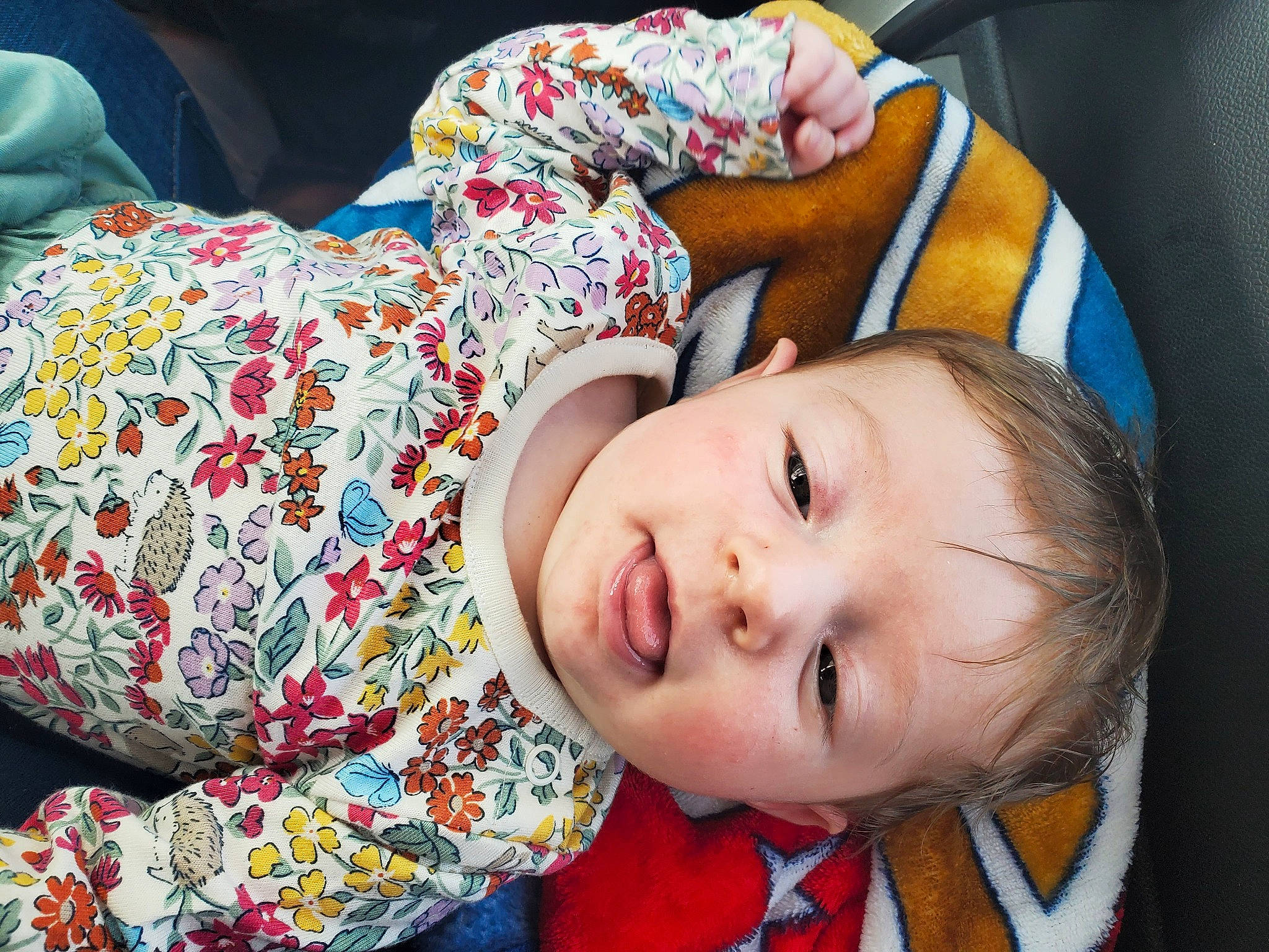 Austin is registered to the contest to win money with this photo: baby, baby_toddler_clothing, cheek, child, comfort, couch, eye, happy, head, linens, mouth, nose, orange, pattern, person, sitting, skin, smile, textile, toddler