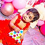 baby, child, red_dress, balloons, party, celebration, floor, polka_dot, hat, cute, jewelry, bracelets, indoor, decoration, confetti, portrait, smiling, festive, person, happy