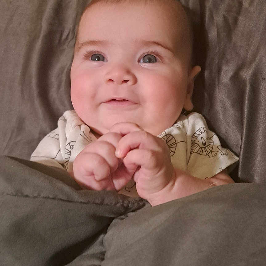 Griffin is registered to the contest to win money with this photo: baby, bed, blanket, bodypart, couch, cushion, face, finger, furniture, hand, happy, head, homedecor, newborn, person, photography, portrait, quilt, sleeping, smile