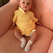 Zeb joined the competition — help win amazing prizes! baby, infant, child, armchair, pink, striped_shirt, yellow_shirt, socks, indoor, furniture, portrait, cute, seated, soft_texture, plush, looking_at_camera, small_hands, small_feet, expression, relaxed