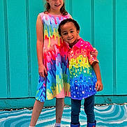 Nyle joined the competition — help win amazing prizes! child, children, smiling, standing, colorful_clothing, rainbow, dress, shirt, boots, spiderman, sneakers, happy, outdoor, wall, turquoise, pattern, friendship, playful, portrait, kids
