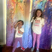 Paislea joined the competition — help win amazing prizes! child, children, girl, posing, smiling, curtain, colorful, flower_pattern, indoor, floor, wooden_floor, casual_clothing, tshirt, leggings, sneakers, playful, happy, portrait, standing, home