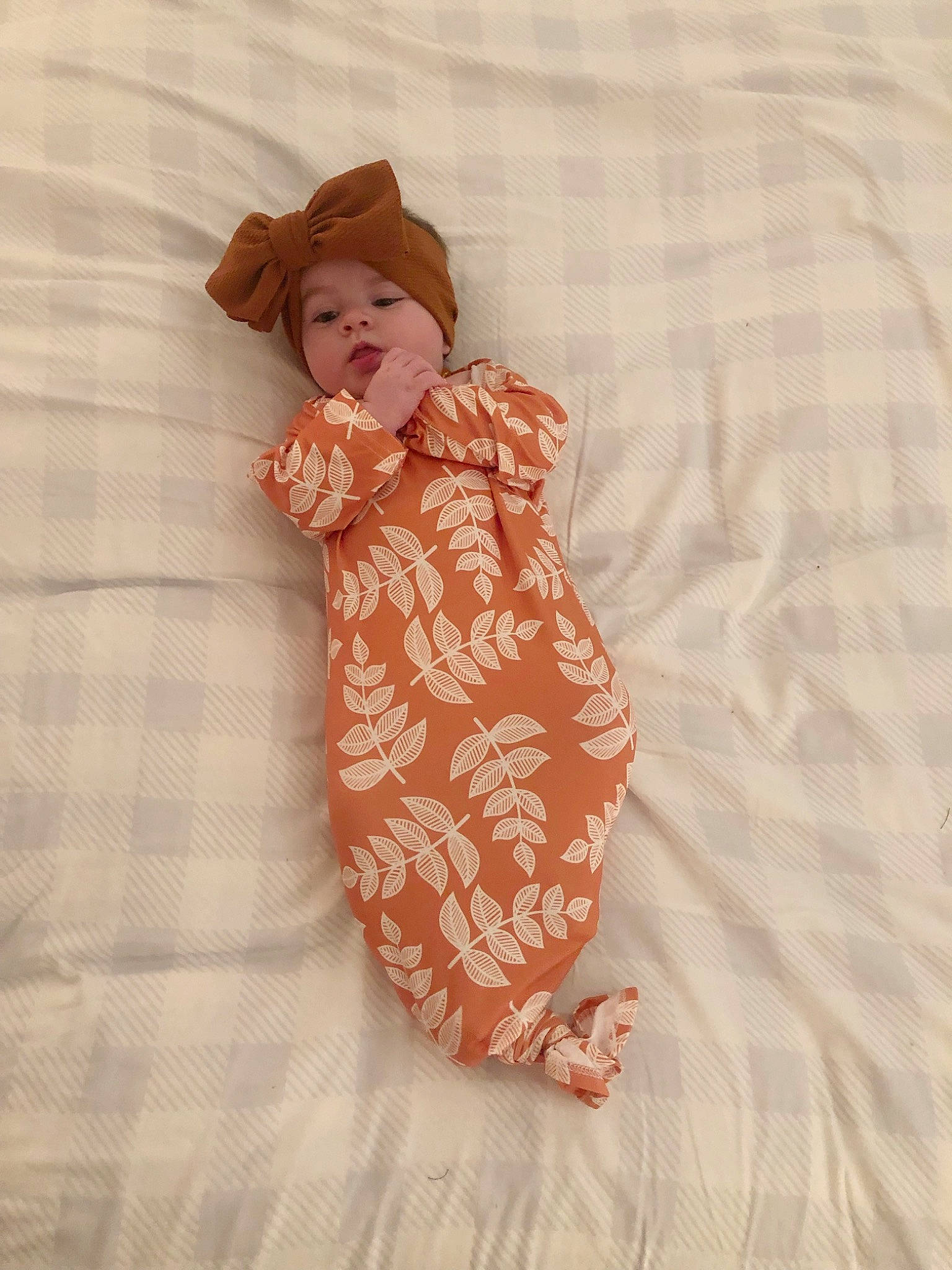 Scarlett is registered to the contest to win money with this photo: baby_toddler_clothing, brown_hair, child, comfort, creative_arts, day_dress, doll, fashion_accessory, fashion_design, hat, headwear, linens, one_piece_garment, pattern, peach, person, skin, sleeve, textile, toy