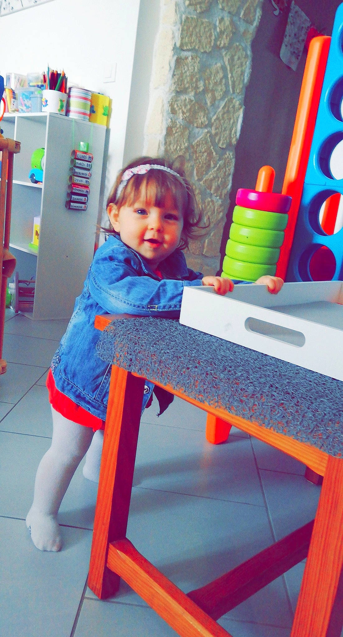 Mila participe au concours pour gagner de l'argent avec cette photo : baby_toddler_clothing, child, clothing, curtain, electric_blue, fun, knee, leisure, magenta, person, pink, product, purple, red, shelf, smile, standing, t_shirt, textile, thigh