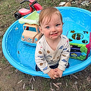 Rollin joined the competition — help win amazing prizes! toddler, child, smiling, outdoor, grass, toys, plastic_pool, dirt, face, clothing, playtime, tricycle, tree, nature, happy, cute, young_child, blue, red, fun