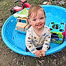 toddler, child, smiling, outdoor, grass, toys, plastic_pool, dirt, face, clothing, playtime, tricycle, tree, nature, happy, cute, young_child, blue, red, fun