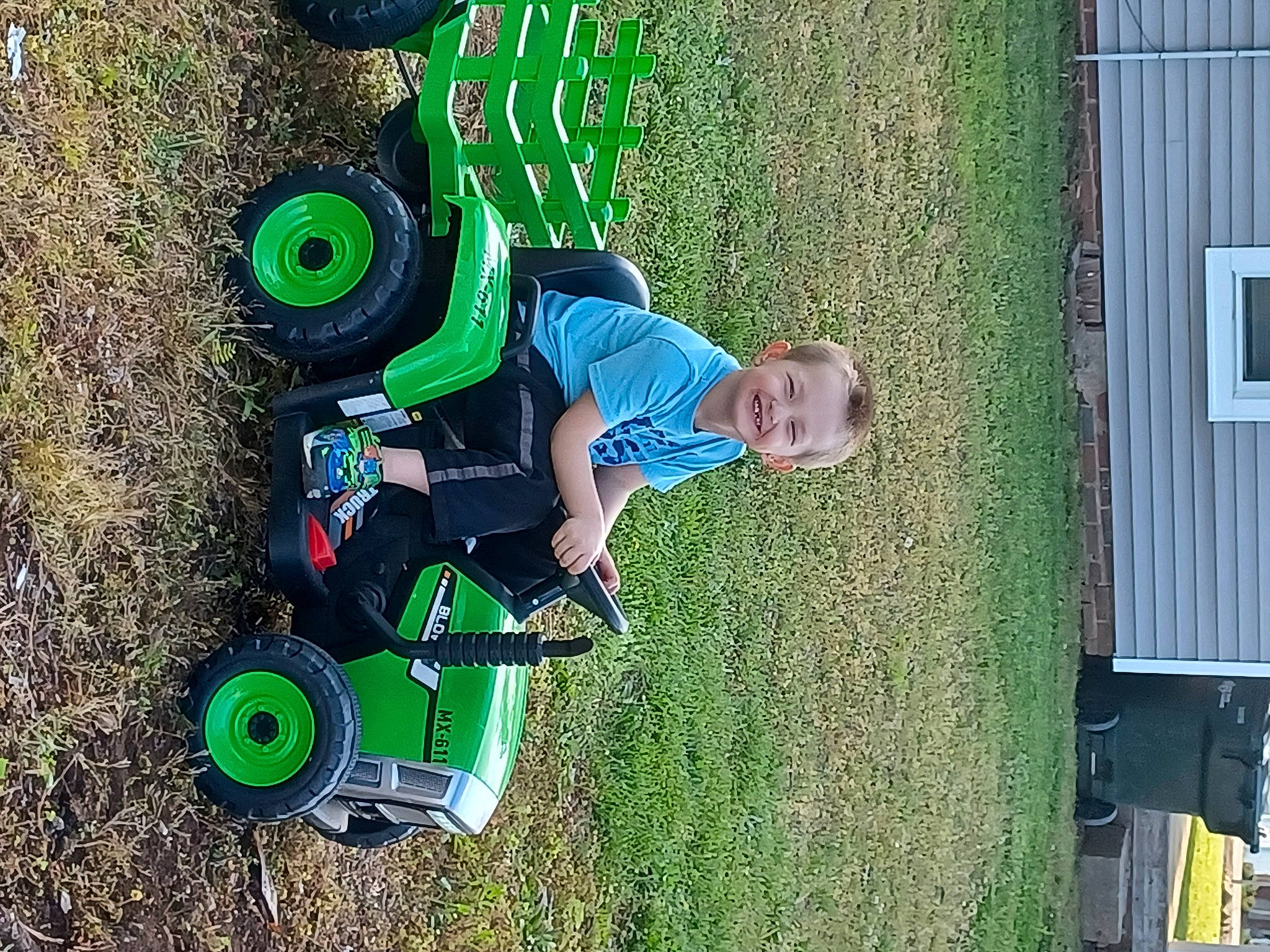 Grayson joined the competition — help win amazing prizes! automotive_tire, child, fun, garden, grass, green, joy, lawn, leisure, people_in_nature, person, plant, play, recreation, smile, soil, t_shirt, tire, toddler, vehicle