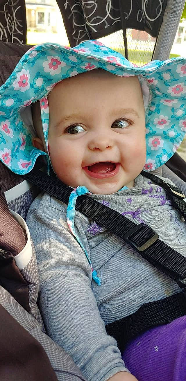 Maci is registered to the contest to win money with this photo: baby, cheek, child, chin, cool, eye, face, facial_expression, hat, head, headgear, headwear, lip, mouth, nose, person, pink, product, skin, smile