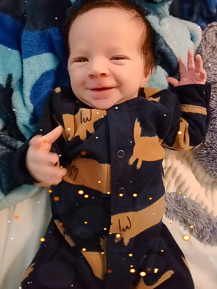 Journey is registered to the contest to win money with this photo: baby, baby_toddler_clothing, beauty, child, collar, electric_blue, finger, formal_wear, gesture, hairstyle, happy, joy, military_uniform, pattern, person, skin, sleeve, smile, textile, thumb