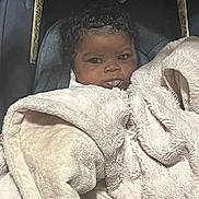 Dionna is registered to the contest to win money with this photo: baby, blanket, bodypart, crib, cushion, face, furniture, happy, head, homedecor, infantbed, laundry, linen, newborn, person, photography, portrait, quilt, smile, towel