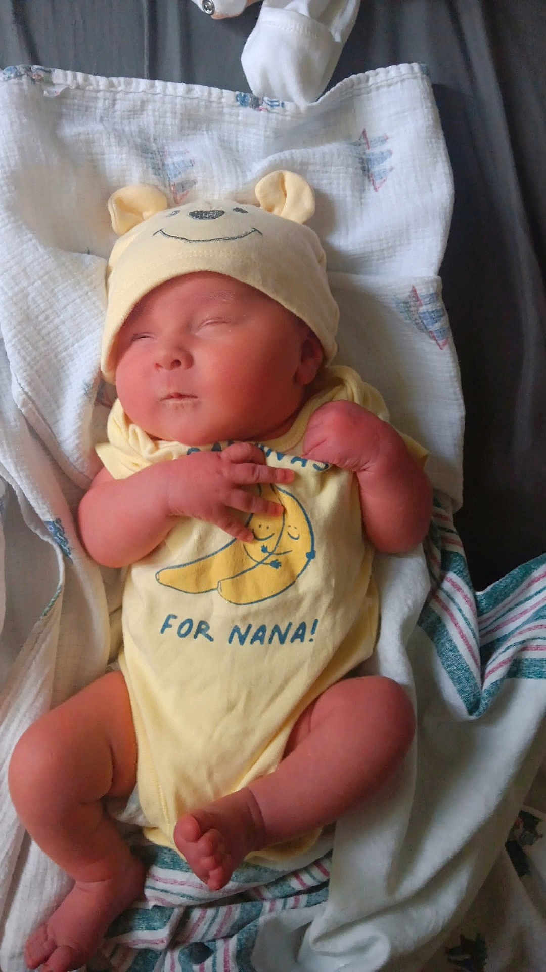 Hunter is registered to the contest to win money with this photo: newborn, baby, sleeping, yellow_onesie, hat, bear_ears, blanket, infant, cute, soft, cozy, toddler, resting, clothing, wrapped, peaceful, indoors, child, person, small