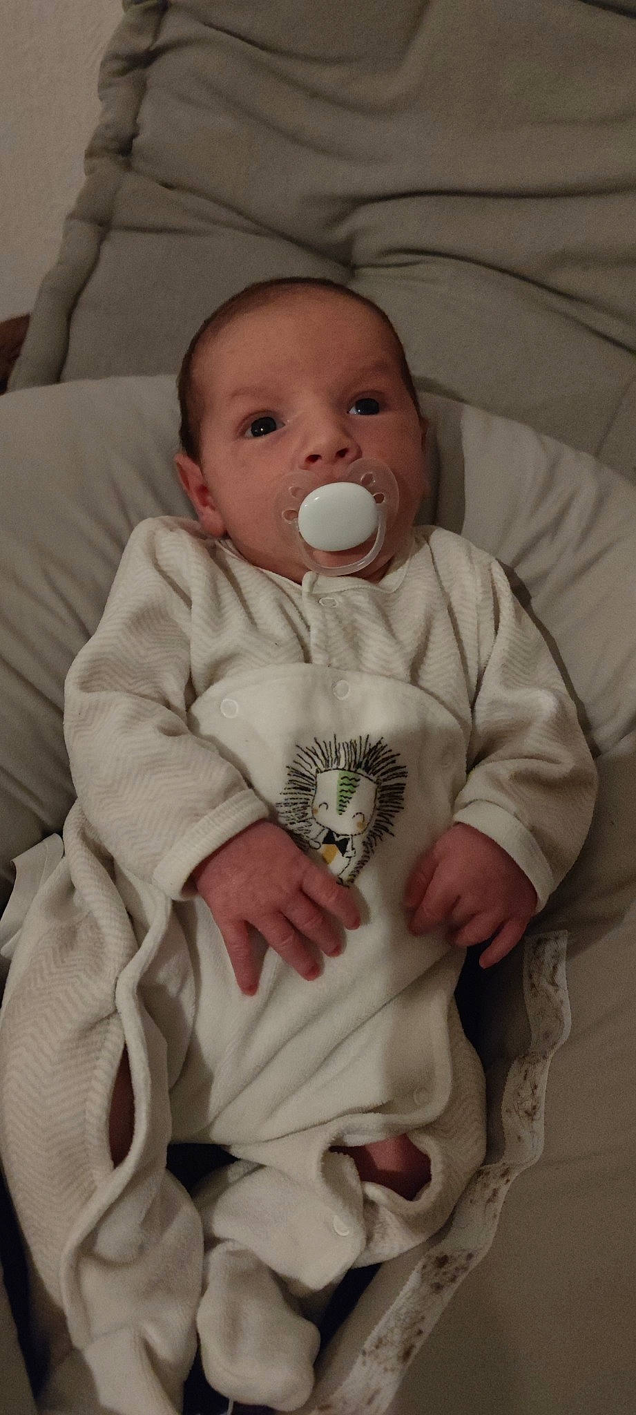 Temoe participe au concours pour gagner de l'argent avec cette photo : baby, baby_products, baby_safety, baby_toddler_clothing, cheek, child, comfort, eye, happy, linens, lip, nose, person, room, sitting, skin, sleeve, smile, textile, toddler