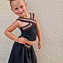Jenna participe au concours pour gagner de l'argent avec cette photo : child, girl, smiling, posing, orange_bows, black_outfit, skirt, top, bracelets, earrings, standing, wall, textured_wall, fashion, happy, cute, portrait, outdoor, tile_floor, confident