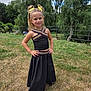 Jenna participe au concours pour gagner de l'argent avec cette photo : child, girl, outdoor, grass, trees, smiling, yellow_hair_bows, black_outfit, skirt, top, posing, nature, sunny, happy, person, fashion, standing, summer, greenery, accessories