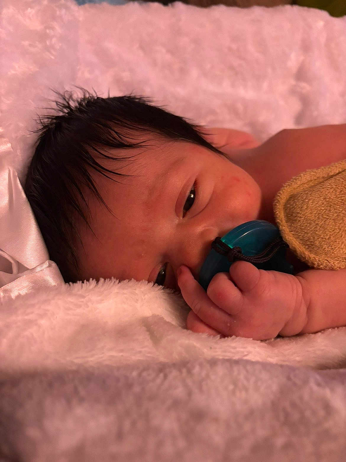 Malachi is registered to the contest to win money with this photo: baby, newborn, pacifier, blanket, sleepy, close_up, hand, face, soft_texture, pink, towel, hair, skin, resting, cozy, portrait, nursery, small_fingers, cuddly, relaxed