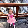 Elliana joined the competition — help win amazing prizes! child, toddler, pink_dress, smiling, curly_hair, waterfall, wooden_railing, outdoor, sunlight, footwear, happy, nature, playful, daylight, person, standing, wood_floor, railing, scenic, cute