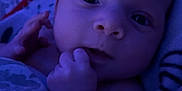 Apaullo is registered to the contest to win money with this photo: baby, blanket, blue_light, child, closeup, cute, expression, face, hand, indoors, infant, newborn, pattern, person, portrait, resting, skin, sleeping_area, soft_light, young_child
