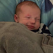 Apaullo joined the competition — help win amazing prizes! baby, blanket, sleeping, smile, cozy, face, infant, soft, wrapped, child, head, comfort, cute, peaceful, indoors, warm, portrait, person, blue, gray