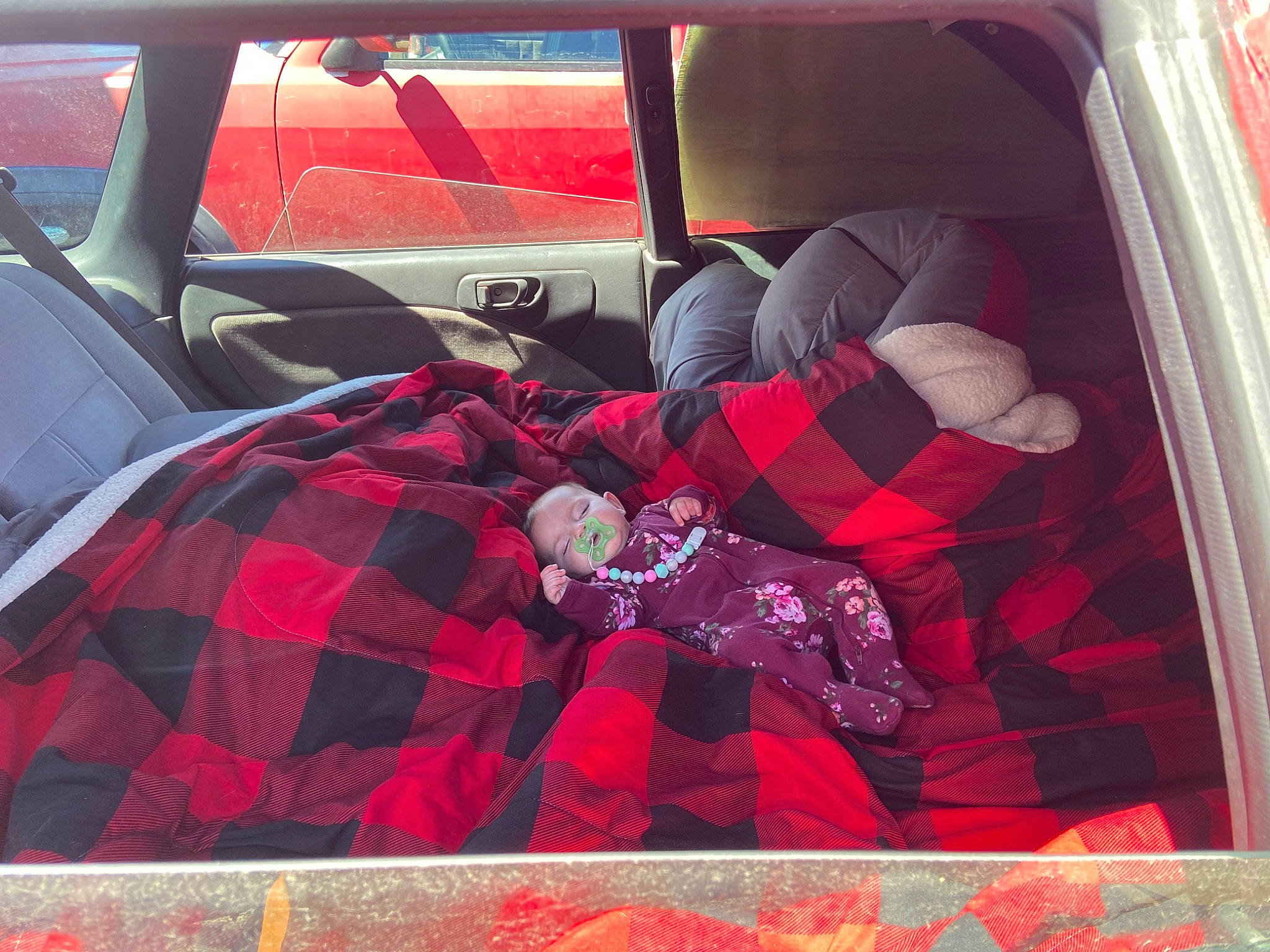 Lillie is registered to the contest to win money with this photo: automotive_design, automotive_exterior, car, car_seat, car_seat_cover, comfort, family_car, head_restraint, motor_vehicle, pattern, person, personal_luxury_car, plaid, red, tartan, textile, tints_and_shades, trunk, vehicle, vehicle_door