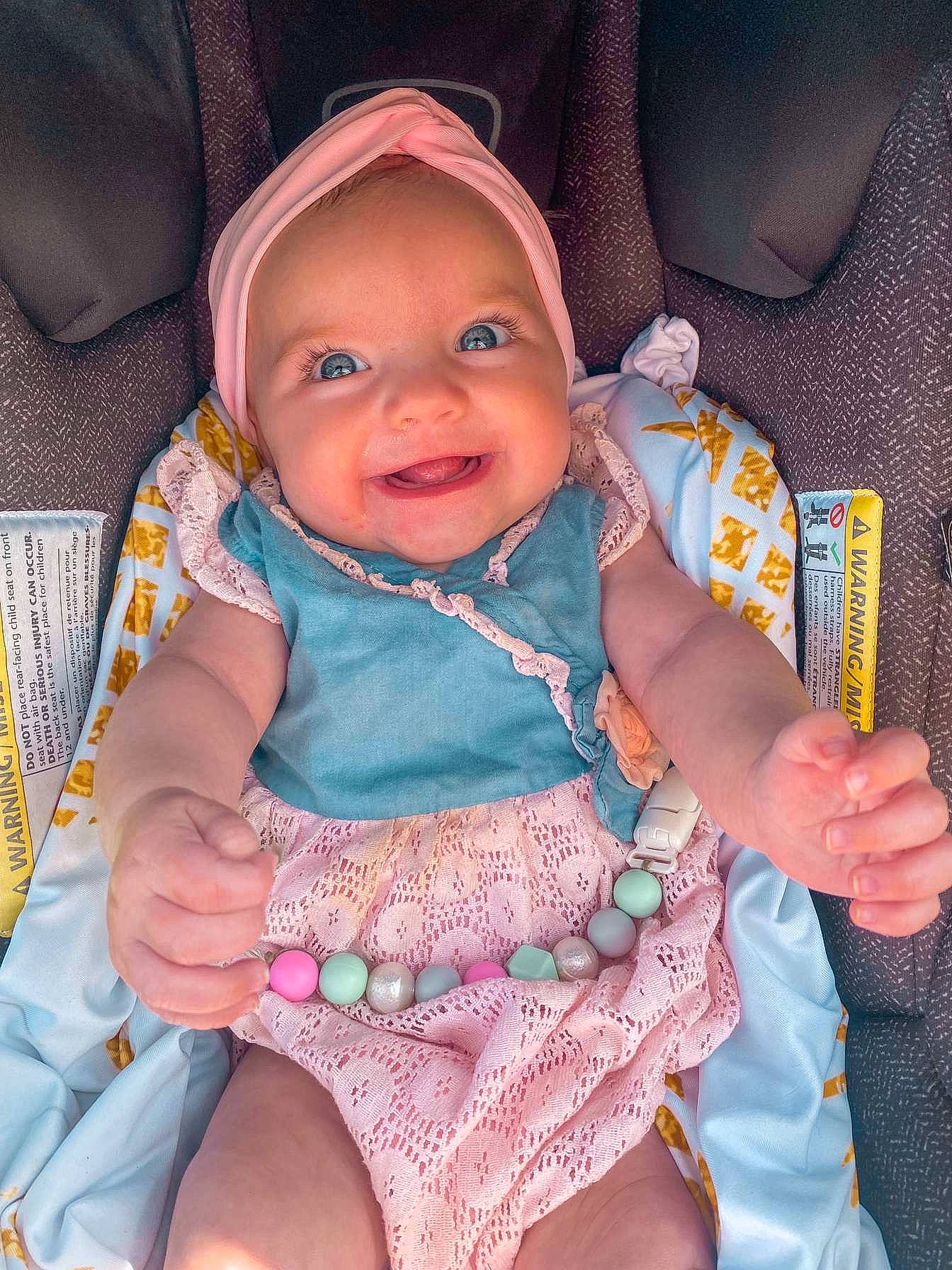 Lillie is registered to the contest to win money with this photo: baby, baby_toddler_clothing, cheek, chin, comfort, eye, finger, hand, head, headwear, human_body, iris, mouth, organ, person, pink, product, purple, skin, sleeve