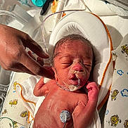 Ty'Aire Avant is registered to the contest to win money with this photo: baby, blanket, care, closeup, diaper, fragile, hand, healthcare, hospital, infant, lion_pattern, medical_tubes, monitoring_electrodes, newborn, nursery, person, premature, skin, sleeping, tender