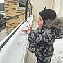 baby, balcony, child, clothing, cold, curious, exploration, face, fingers, frost, hat, outdoor, profile, railing, snow, snowsuit, snowy, toddler, winter, winterwear
