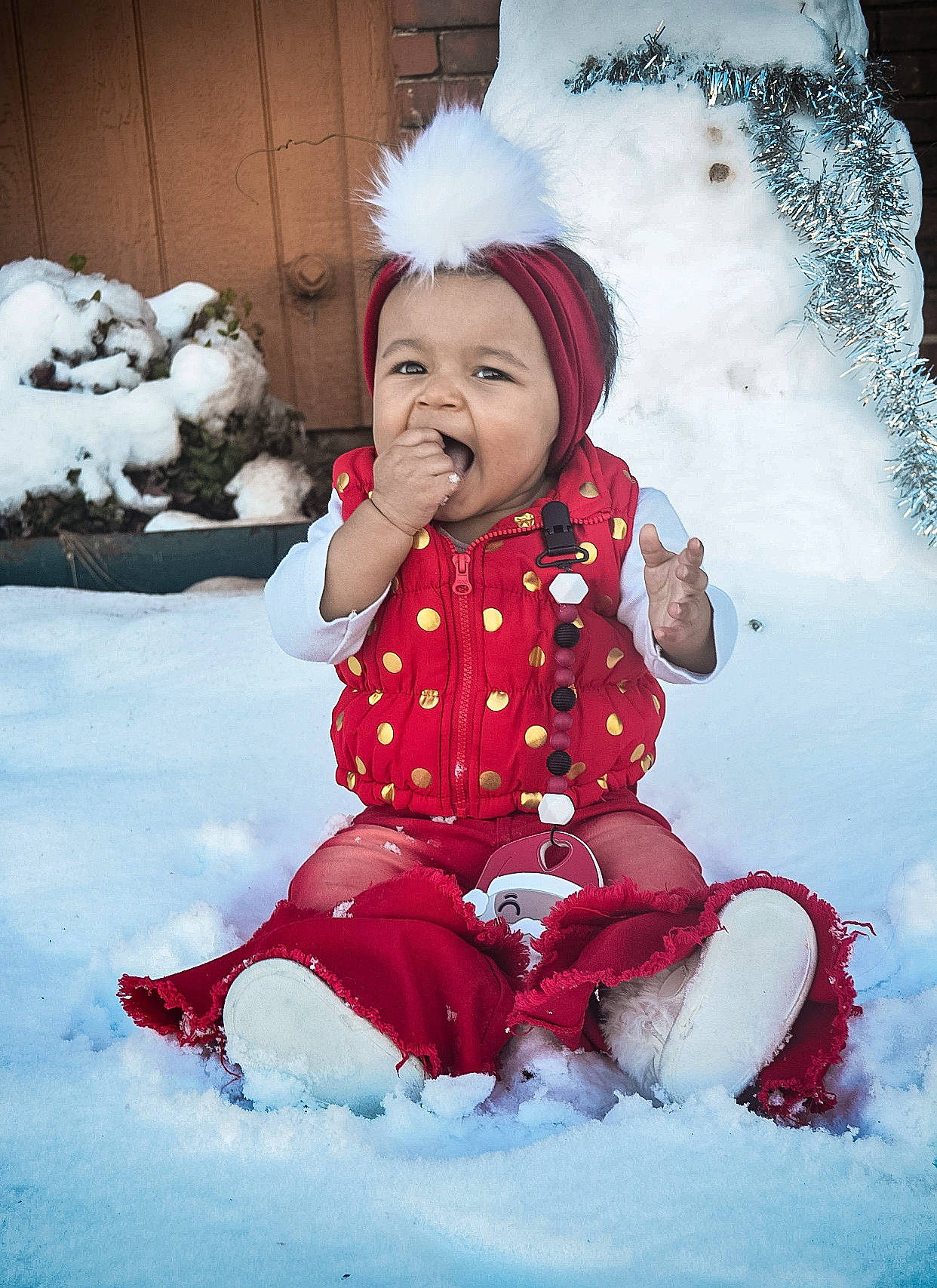 Myla joined the competition — help win amazing prizes! baby, baby_toddler_clothing, boot, cheek, child, child_model, costume_accessory, costume_hat, freezing, headwear, overall, person, playing_in_the_snow, playing_with_kids, portrait_photography, sitting, snow, toddler, winter