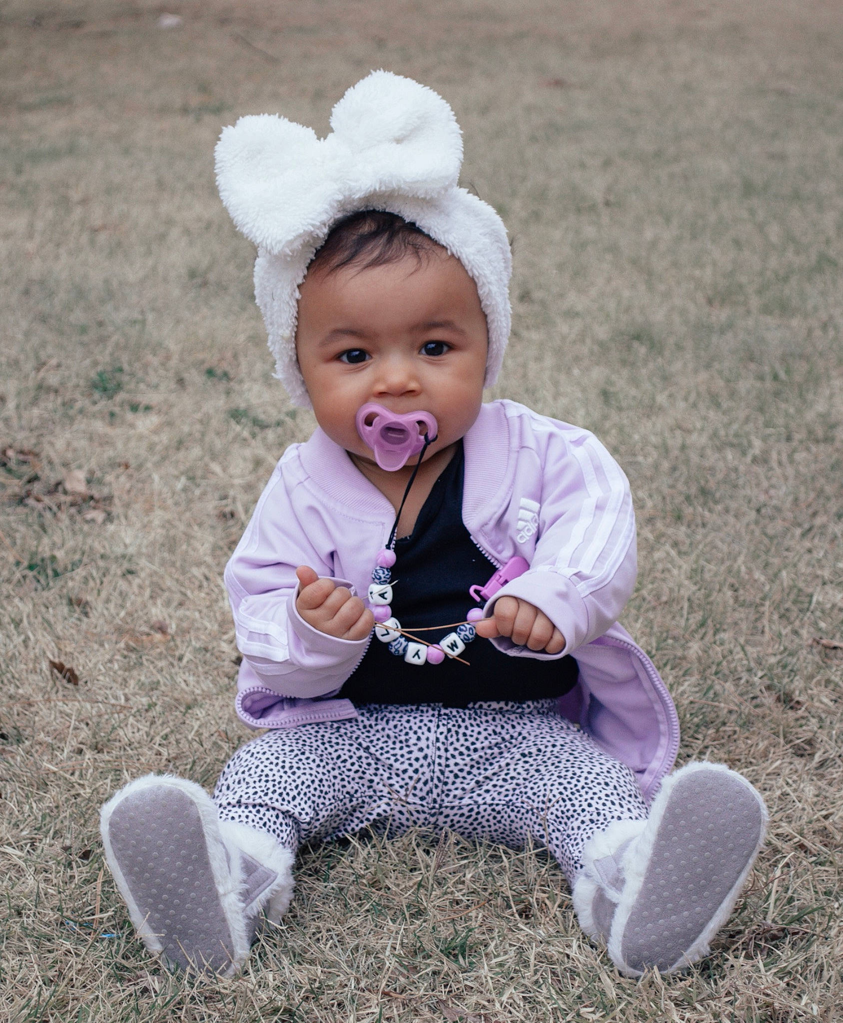 Myla joined the competition — help win amazing prizes! blue, clothing, eye, face, finger, fun, grass, green, head, human, leg, natural_environment, nature, people, person, product, shoe, sitting, vertebrate, winter