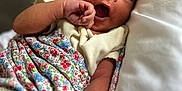 Charlotte Elizabeth is registered to the contest to win money with this photo: arm, baby, blanket, child, clothing, cozy, cute, floral_pattern, hand, indoors, infant, newborn, pillow, portrait, resting, skin, sleepy, soft, toddler, yawning