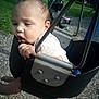 baby, child, swing, playground, outdoor, grass, woodchips, metal, seat, infant, person, summer, daylight, park, cute, expression, holding, clothing, head, face
