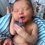 Finley is registered to the contest to win money with this photo: baby, blanket, child, closeup, comfort, cute, foot, hand, indoors, infant, newborn, pacifier, peaceful, resting, skin, sleeping, soft_toys, striped_blanket, toddler, wrapped