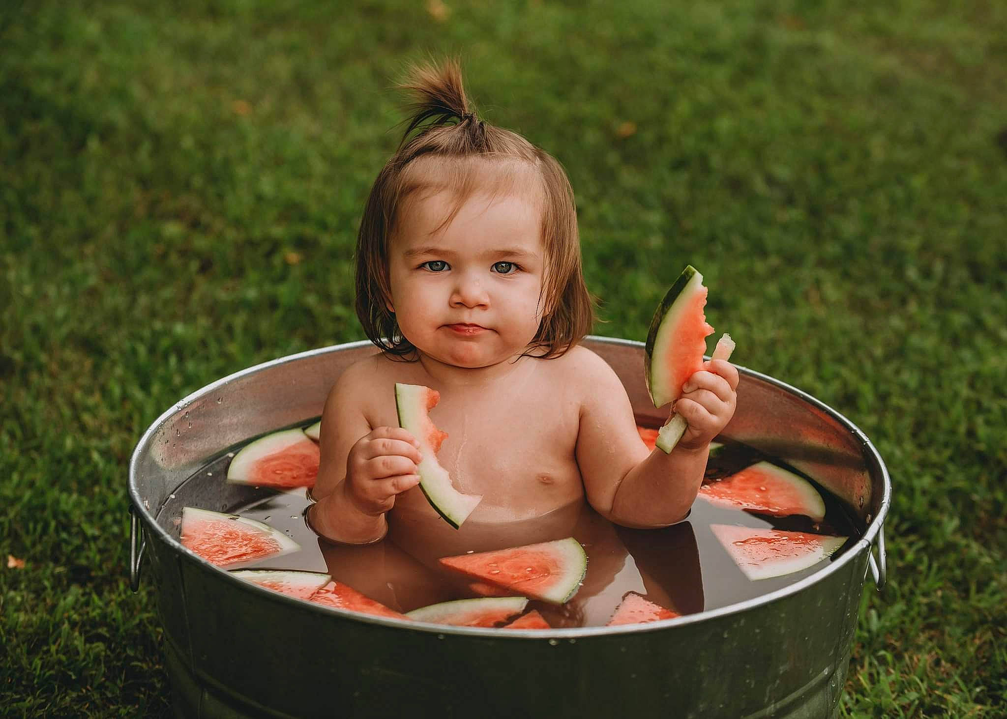 Davina is registered to the contest to win money with this photo: baby, baby_products, bathing, bowl, child, face, finger, fun, grass, hand, happy, head, leisure, people_in_nature, person, plant, recreation, sitting, skin, thumb