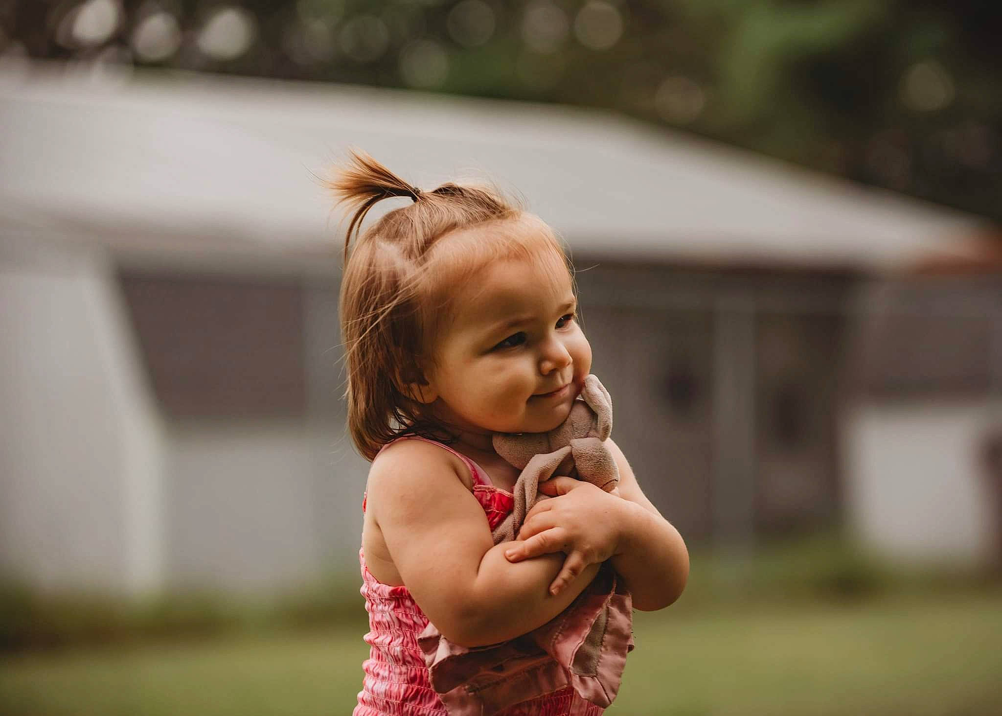 Davina is registered to the contest to win money with this photo: baby, child, dress, face, flash_photography, fun, gesture, grass, happy, laugh, leisure, people_in_nature, person, plant, portrait_photography, recreation, sitting, smile, toddler, toy