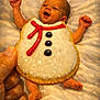 Asher is registered to the contest to win money with this photo: baby, background, black_icing, blanket, celebration, cookie, cozy, cute, food, frosting, hand, happy, holiday, infant, lying_down, red_icing, smiling, snowman_cookie, sweet, texture