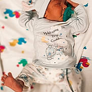 Kamdyn is registered to the contest to win money with this photo: newborn, baby, sleeping, pacifier, bunny_hat, pajamas, blanket, infant, cute, cozy, patterned_blanket, lying_down, soft_toys, colorful, child, peaceful, indoors, small, adorable, resting