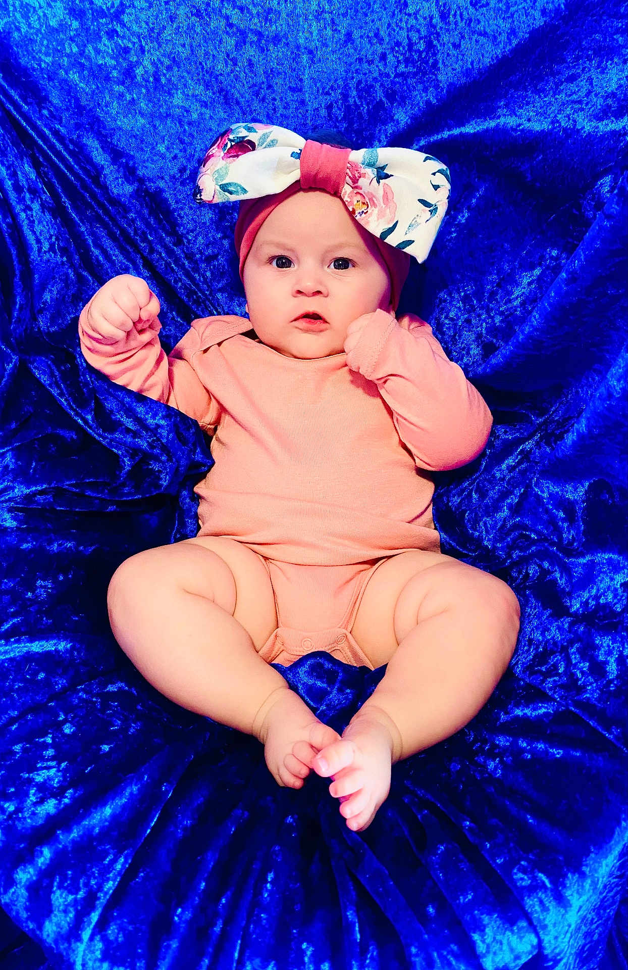 Larkyn joined the competition — help win amazing prizes! baby, infant, headband, bow, pink_clothing, blue_fabric, velvet, lying_down, chubby_legs, bare_feet, cute, portrait, child, soft_texture, curious_expression, indoors, closeup, person, skin, small_toes