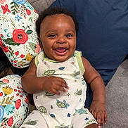 Prince joined the competition — help win amazing prizes! baby, child, clothing, colorful, couch, cute, fabric, floral_pattern, furniture, happy, indoor, infant, onesie, person, pillow, portrait, relaxed, sitting, smile, turtle_print