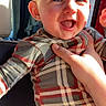 baby, child, smiling, plaid, pajamas, hand, car, seat, sunlight, happy, cute, portrait, infant, clothing, person, indoor, young, face, head, warm