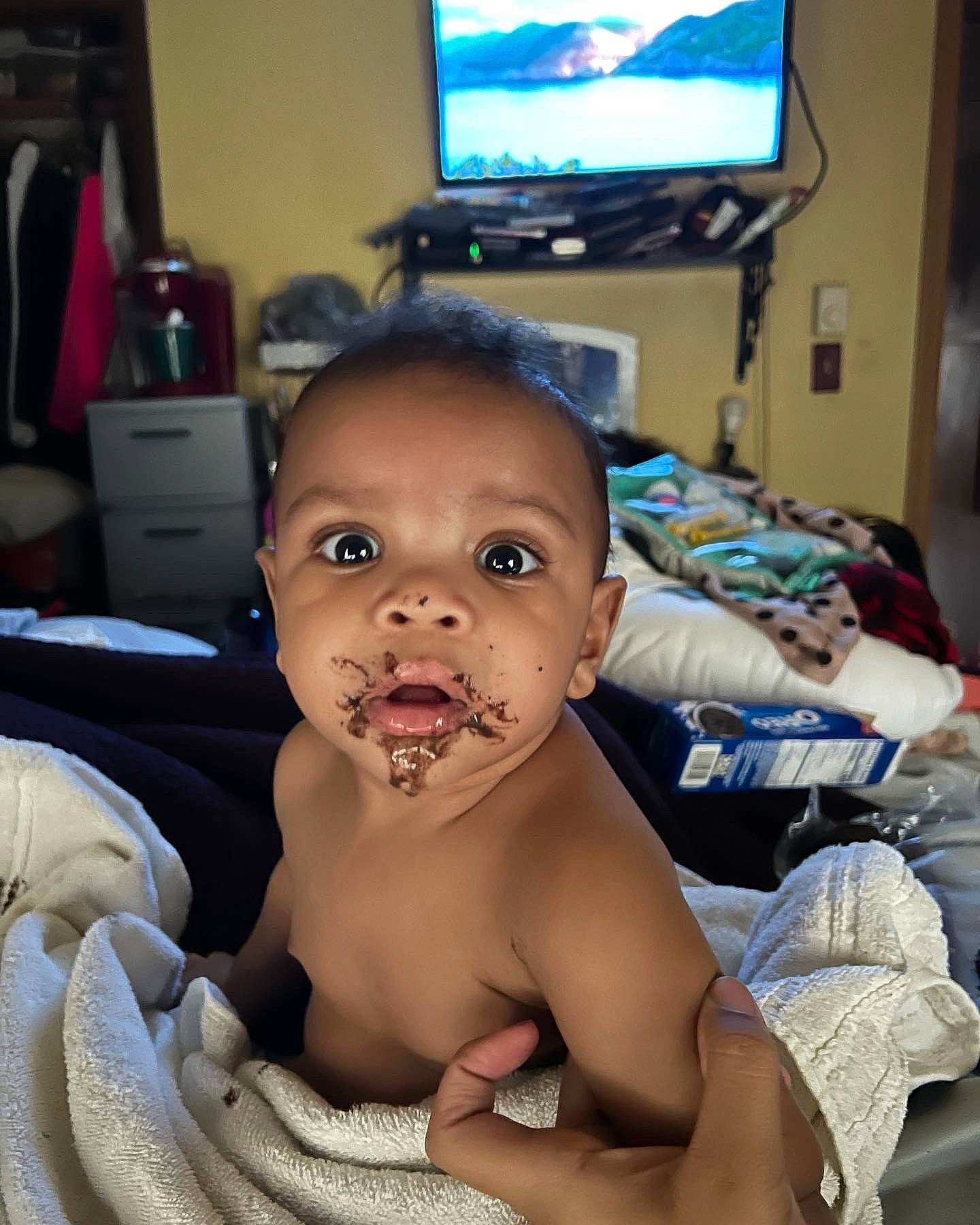 Kyrie is registered to the contest to win money with this photo: baby, cheek, chest, child, ear, eye, eyelash, finger, happy, home_appliance, jaw, mouth, nose, person, room, skin, television, television_set, thumb, toddler