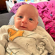 Lyam participe au concours pour gagner de l'argent avec cette photo : baby, infant, face, eyes, sweater, clothing, cartoon, indoor, portrait, child, cute, person, blanket, bottle, furniture, home, cozy, expression, smile, head