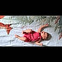 baby, infant, child, lying_down, striped_clothing, romper, blanket, patterned_blanket, happy, playful, arms_up, legs_up, indoor, cute, smile, head, person, skin, young_child, resting