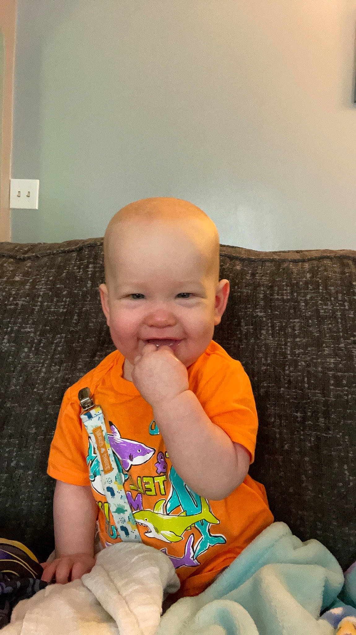 Daxton is registered to the contest to win money with this photo: baby, baby_toddler_clothing, chair, cheek, child, chin, comfort, couch, eye, flooring, fun, human_body, iris, joy, mouth, person, sitting, skin, sleeve, smile
