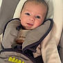 Thélio a rejoint le concours — aidez-le/la à gagner de superbes lots ! baby, infant, child, seat, baby_seat, blanket, clothing, face, eyes, smile, indoor, cushion, soft, cozy, person, portrait, young_child, cute, comfort, baby_gear