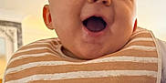 Teddie joined the competition — help win amazing prizes! baby, smiling, bib, striped, indoor, closeup, happy, child, face, mouth_open, light, person, infant, cute, skin, head, cheerful, apparel, young, expression