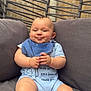 Teddie joined the competition — help win amazing prizes! baby, child, smile, blue_bib, onesie, sitting, cushion, chair, wooden_fence, wicker_chair, indoors, cute, chubby, happy, face, hands, legs, infant, portrait, cozy