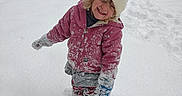 Octavia is registered to the contest to win money with this photo: child, cold_weather, curly_hair, daylight, footprints, fun, gloves, happy, hat, house, jacket, nature, outdoor, pants, play, smile, snow, snowy_ground, toy_truck, winter_clothing