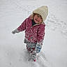 Octavia is registered to the contest to win money with this photo: child, snow, winter_clothing, hat, gloves, footprints, toy_truck, smile, outdoor, cold_weather, play, snowy_ground, house, curly_hair, jacket, pants, happy, daylight, nature, fun