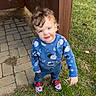 Isaiah joined the competition — help win amazing prizes! toddler, child, curly_hair, blue_sweatshirt, space_pattern, sneakers, grass, pavement, outdoor, smiling, person, standing, casual_clothing, daylight, cute, young_child, wooden_post, nature, happy, playful