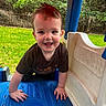 toddler, child, smiling, playground, blue, plastic, outdoor, greenery, grass, trees, climbing, happy, cute, person, casual_clothing, daylight, play_structure, fun, young, baby