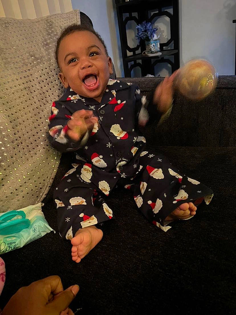 Jacory is registered to the contest to win money with this photo: baby, baby_toddler_clothing, barefoot, cheek, child, comfort, finger, floor, flooring, foot, fun, gesture, happy, pattern, person, sitting, sleeve, smile, thigh, thumb